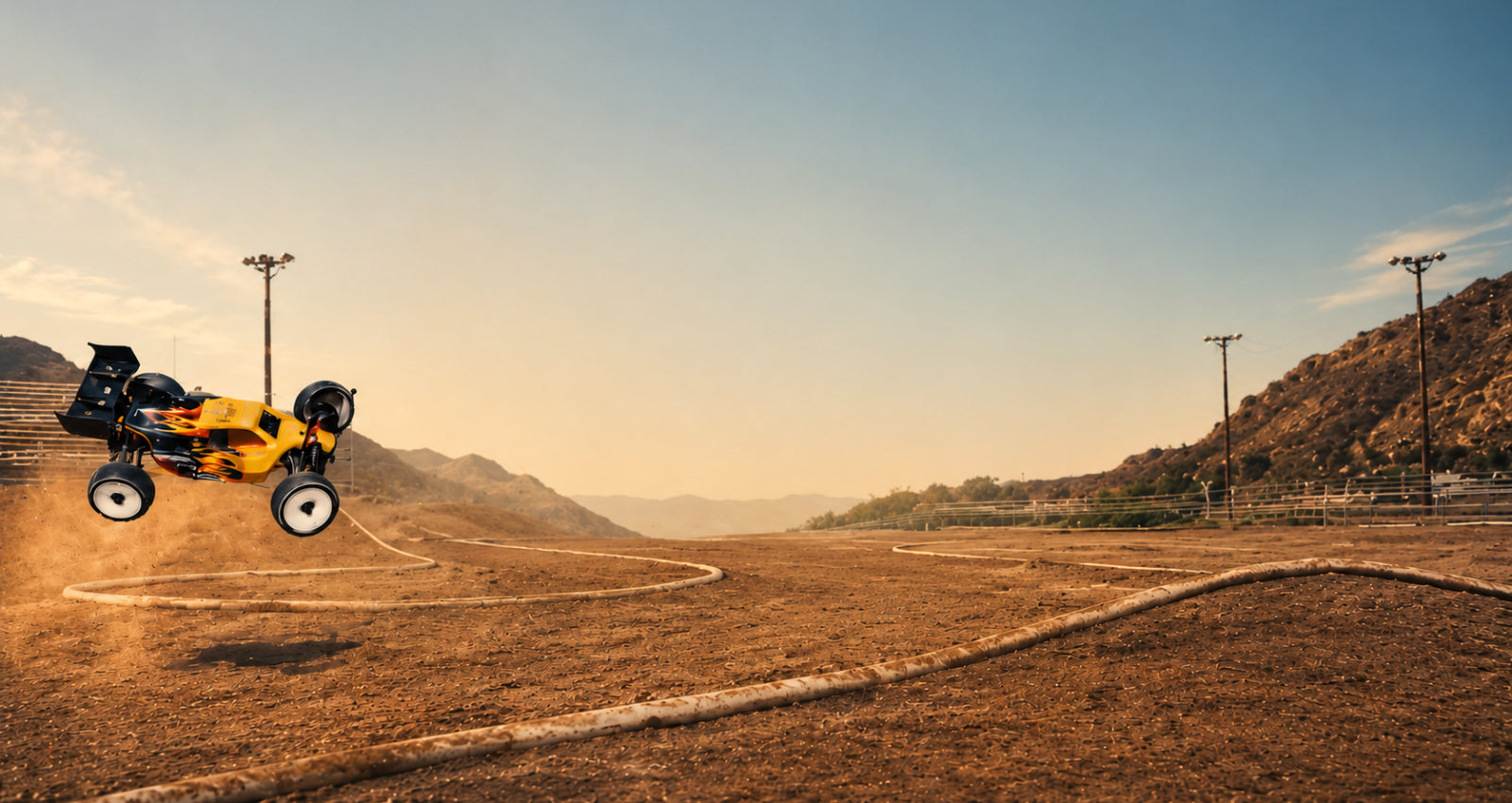 Yellow off-road vehicle on a dirt track with mountains in the background